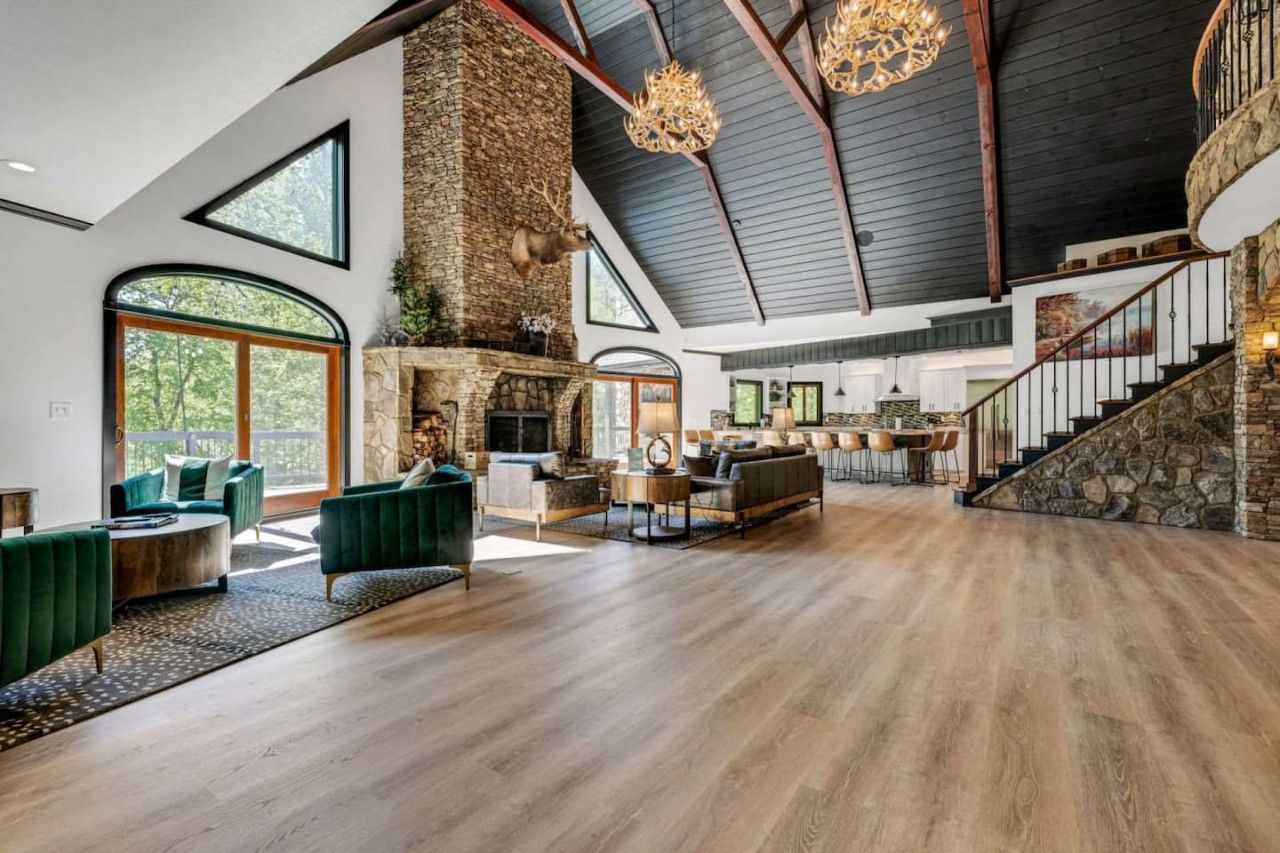 Luxury mountain cabin interior with stone fireplace and vaulted ceilings