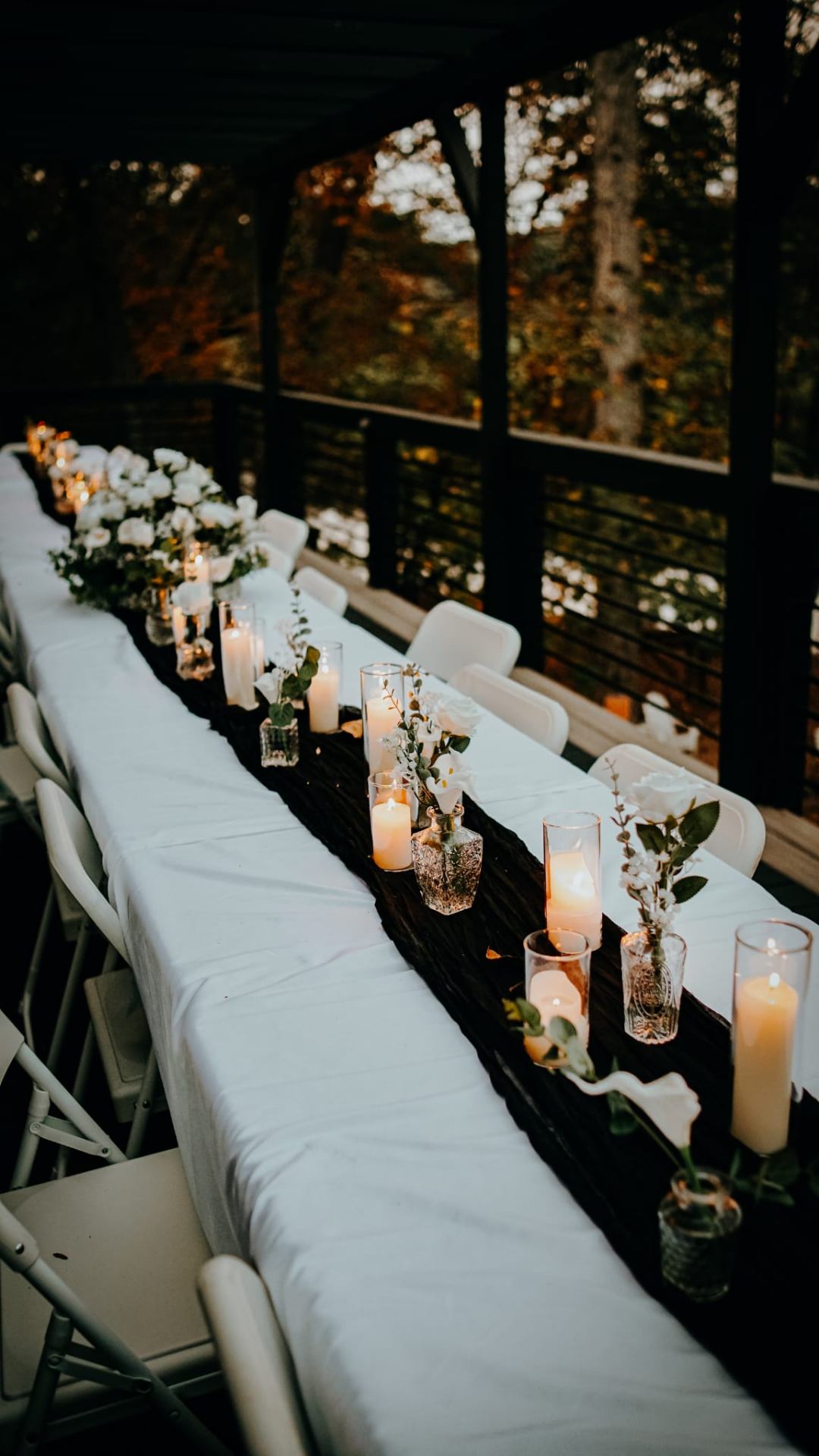 Candlelit reception table on the covered porch